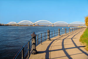 Walking along the river front with a view of the Centennial Bridge