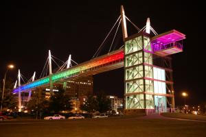 Looking up at the skybridge at night with all the rainbow lights on