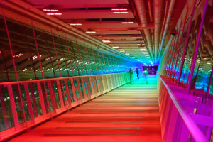 Inside the skybridge at night with all the rainbow lights on